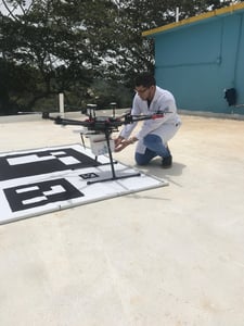 Hospital staff place delivery box on the drone