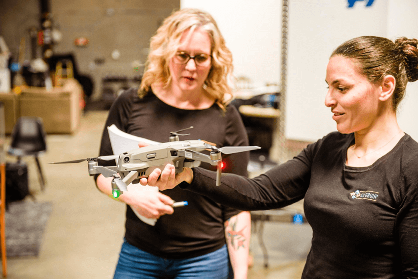 C2 Group’s VP of Program Development, Nicole Alarcon, watches on as C2 President and Co-Founder Omneya Salem inspects a DJI Mavic 2. Image courtesy of C2 Group