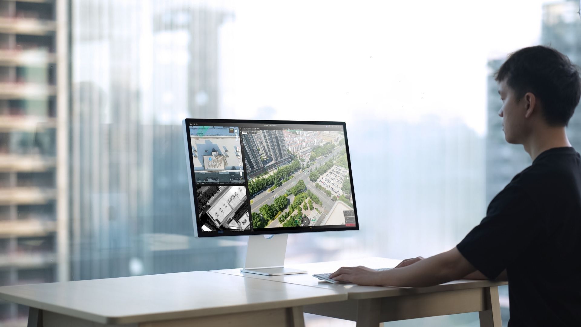 Operator viewing DJI FlightHub 2 drone and site feeds on a desktop monitor